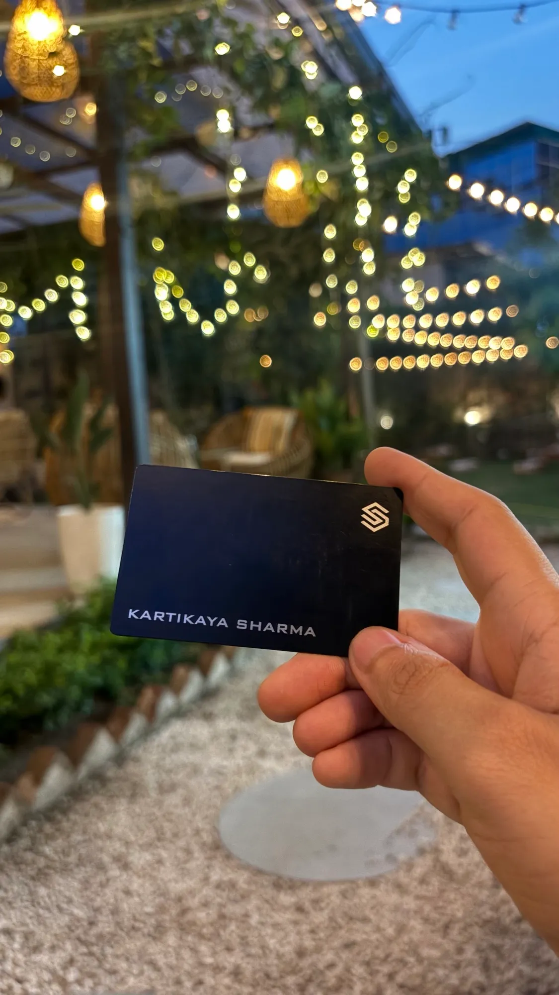 Close-up of the BLACKCARD smart NFC card against bokeh lights